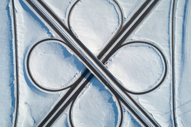 istock Road circle in winter snow background 1356750050