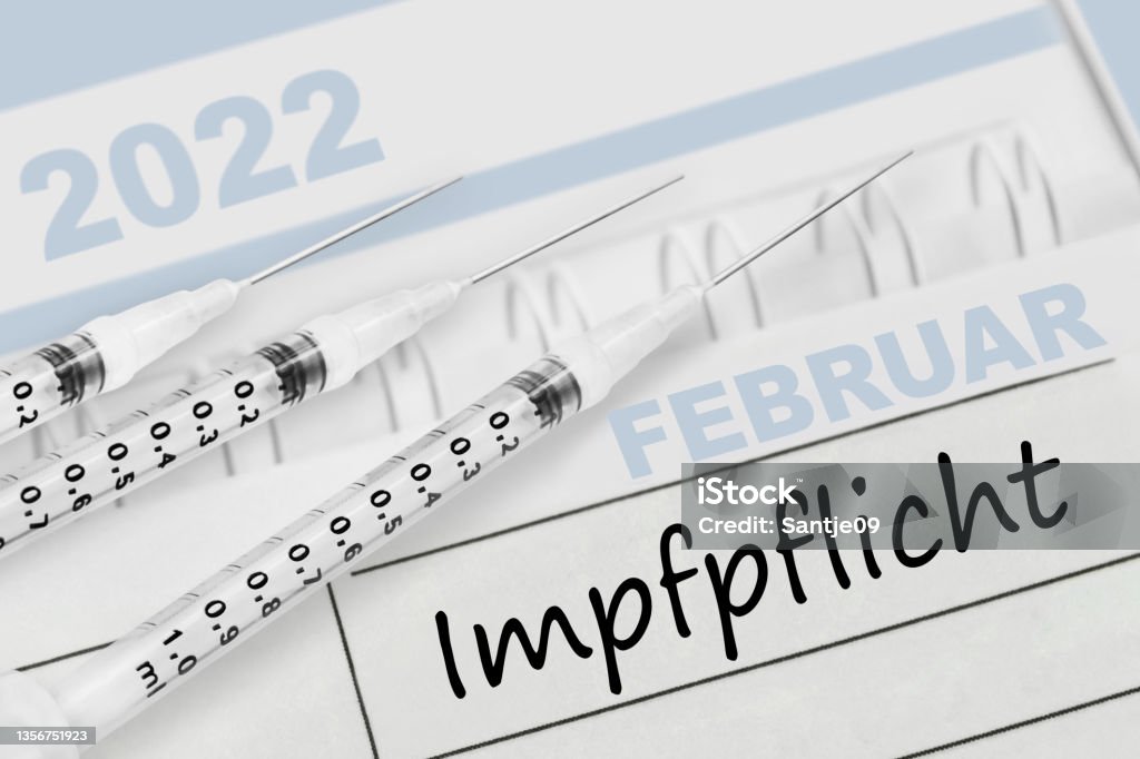 German calendar 2022  February and Corona Compulsory Vaccination with 3 injections Vaccination Stock Photo
