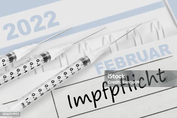 German Calendar 2022 February And Corona Compulsory Vaccination With 3 Injections Stock Photo - Download Image Now