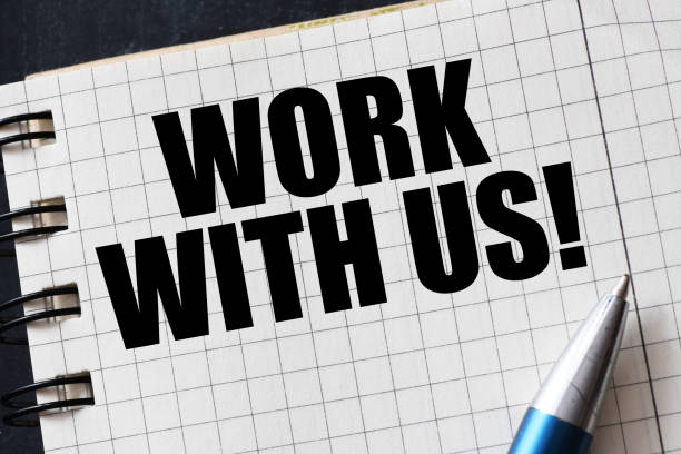istock WORK WITH US words in an office notebook. Concept for business. 1356752773