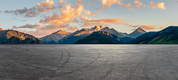Empty asphalt road and mountain natural scenery at sunrise. Road and mountain background.