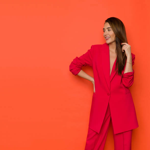 istock Beautiful young woman is posing in oversize red suit 1356755264