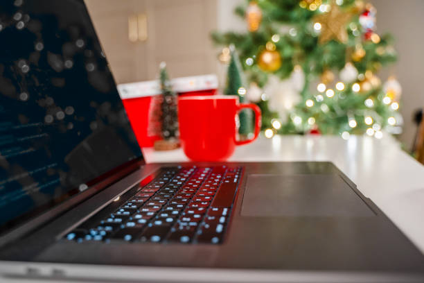istock Selective focus on laptop keyboard with Christmas tree background 1356755723