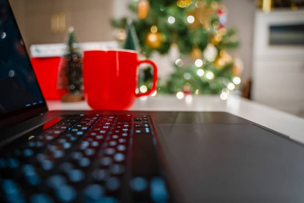 istock Selective focus on laptop keyboard with Christmas tree background 1356755742