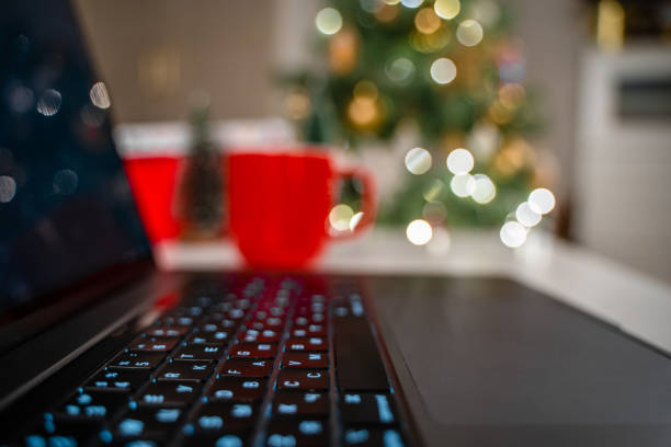 istock Selective focus on laptop keyboard with Christmas tree background 1356755756