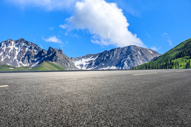 istock Asphalt road and mountain under blue sky 1356757367