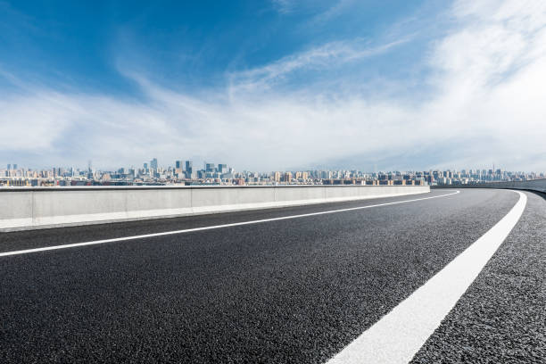 istock Asphalt road and modern buildings with skyline 1356758379