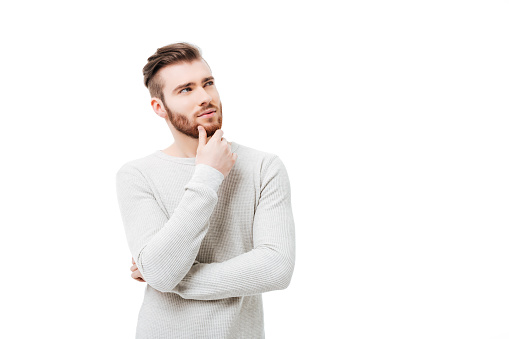 Pensive curious man looking up in thinking pose trying to make a choice or desicion isolated