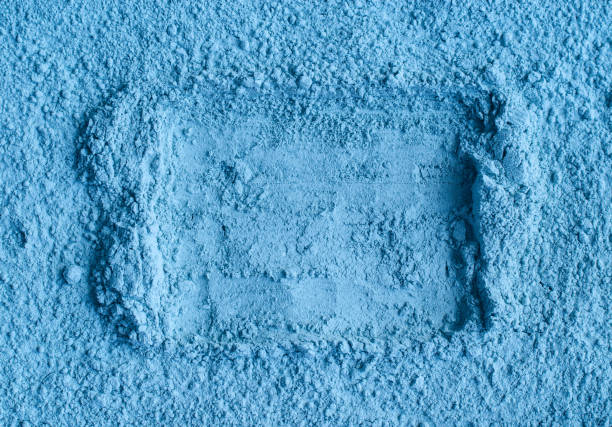 istock Light blue bentonite facial clay powder (alginate mask, body wrap) texture close up, selective focus. Abstract background with brush stroke and place for text. 1356759770