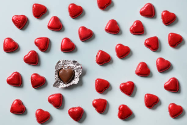 istock Pattern of red sweets romantic as heart on blue. Valentine's day, 1356760365