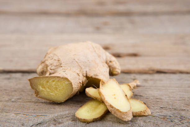 istock Ginger tea in a cup on wooden background 1356760414