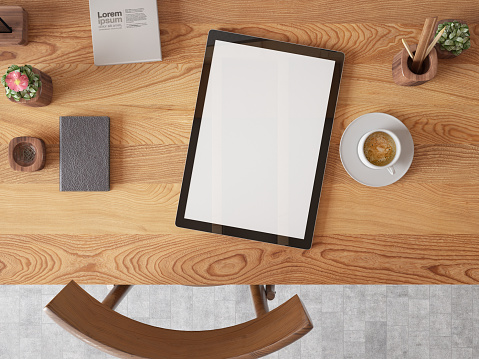 Above View of a Workspace with Empty Digital Tablet Screen