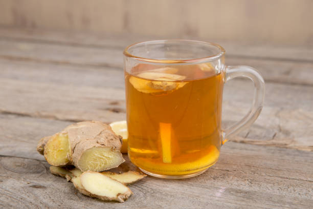 istock Ginger tea in a cup on wooden background 1356761301