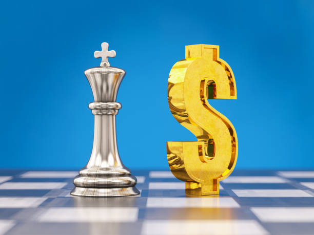 istock US Dollar Sign with King Chess Piece on Chess Board 1356761900