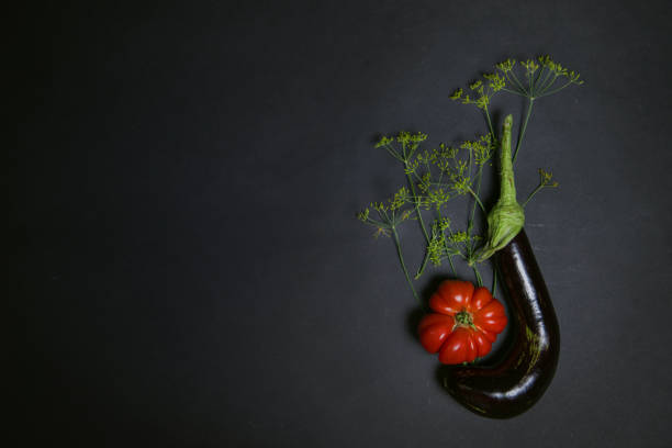 Creative layout of vegetables, dill with eggplant and ribbed tomatoes on a dark background.Flat lay. The concept of nutrition. layout of summer vegetables for advertising. vegetarianism. copy space