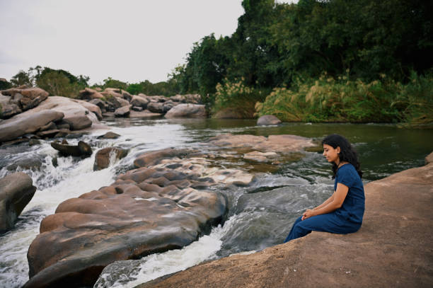 istock Woman relaxing near a stream 1356763907