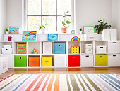 istock White nursery room with shelves and colourful boxes. 1356770765