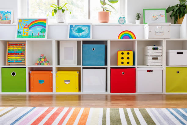 istock White nursery room with shelves and colourful boxes. 1356770825