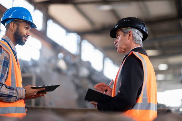 istock Shredder manager and site manager talking at the recycling facility 1356772454