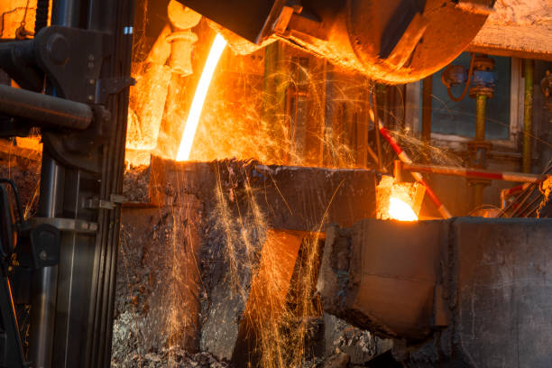 istock Pouring of liquid molten metal to casting mould using forklift 1356772471