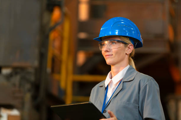 istock Mature woman holding digital tablet in foundry 1356772475
