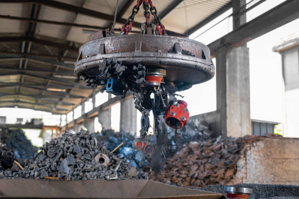 istock Scrap metal released into a metal shredder using industrial magnet 1356772476