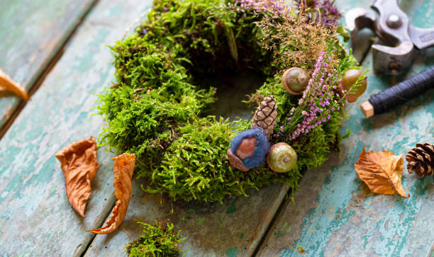 istock Crafting autumnal decoration - wreath with moss 1356773415