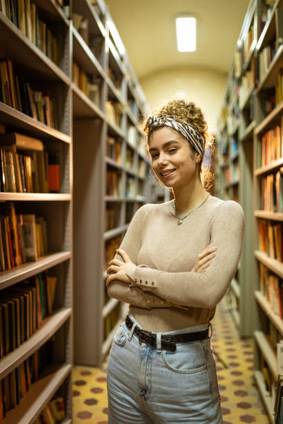 istock Smiling woman at the library 1356776884