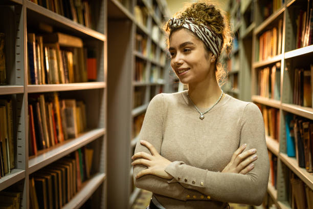 istock Smiling woman at the library 1356776904