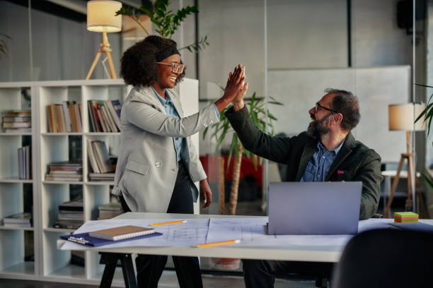 istock Two business people high-five. Job well done. 1356776919