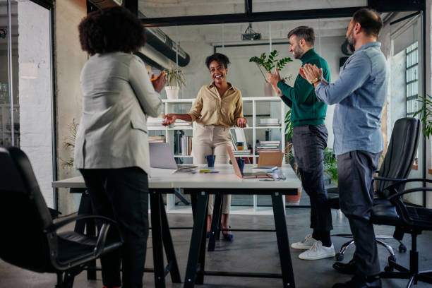 istock Group of diverse workers applaud for a job well done 1356777019
