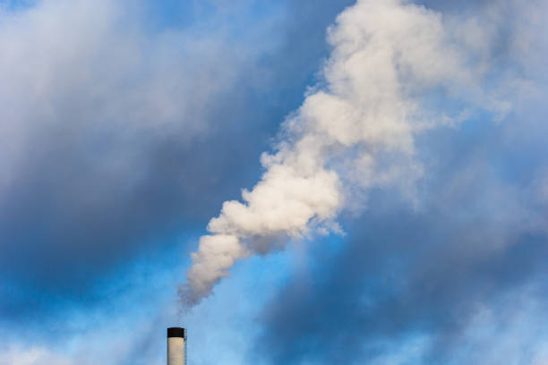 Air pollution coming from an industrial chimney stock photo