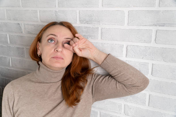 istock A grown woman is trying to stop crying. 1356778489