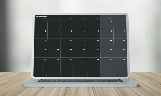 January 2022 calendar on laptop screen. Organization and Planning Concept.