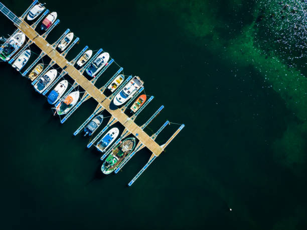 Aerial top down view. Marina dock basin with moorings and supplies for yachts and small fishing boats.