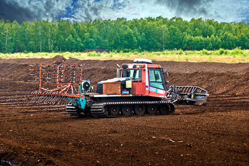 Mining and extraction of peat with a tracked vehicle in a bog area