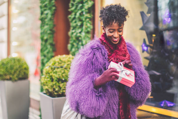 istock Young woman is buying presents 1356780901