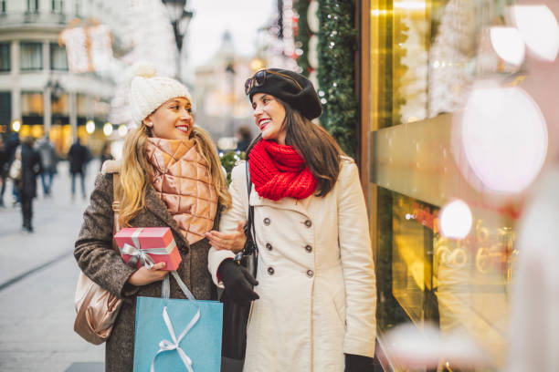 istock Friends are buying Christmas presents 1356781388