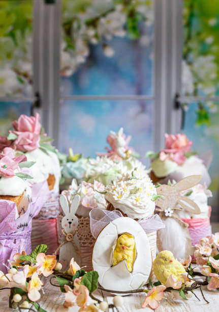 istock Easter composition with orthodox sweet breads or kulich decorated with white sugar icing and mastic flowers. Traditional Orthodox cake. Holiday concept. 1356783851