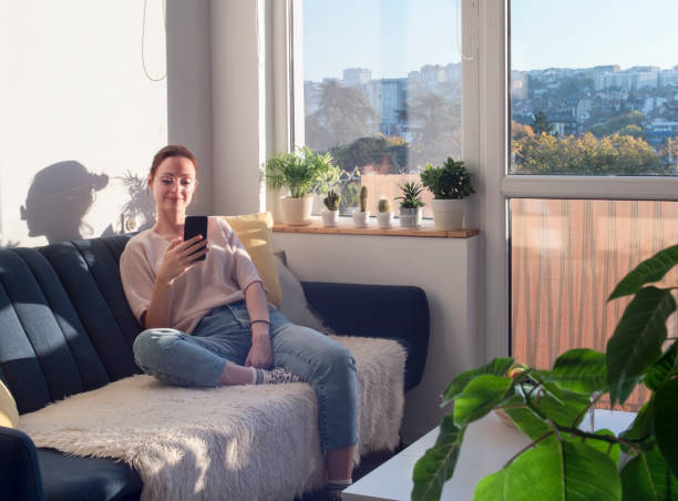 istock Woman morning routine, having a video call on a sofa 1356785364