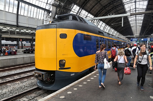 People exit Nederlandse Spoorwegen (NS) train in Amsterdam. NS is the principal Dutch public railway company, operating 4,800 domestic trains daily.
