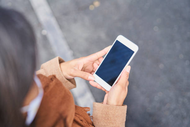 istock Overhead picture of woman using smartphone with visible blank screen 1356785412