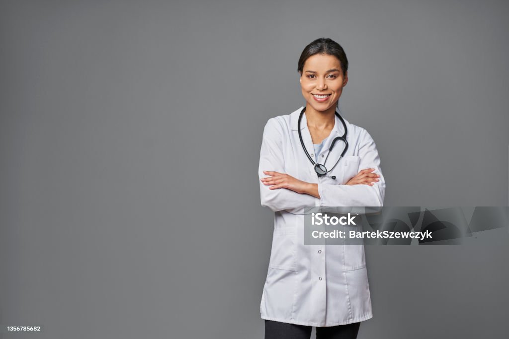 Successful female doctor isolated on grey background Doctor Stock Photo