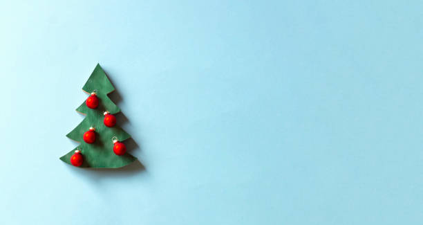 istock Christmas tree and decoration on light blue background. 1356785780