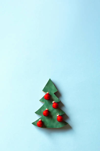 istock Christmas tree and decoration on light blue background. 1356786438
