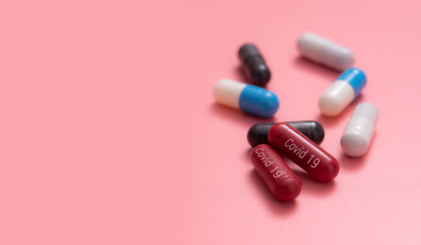 istock Multicolored pills,various capsule on a pink background 1356786737