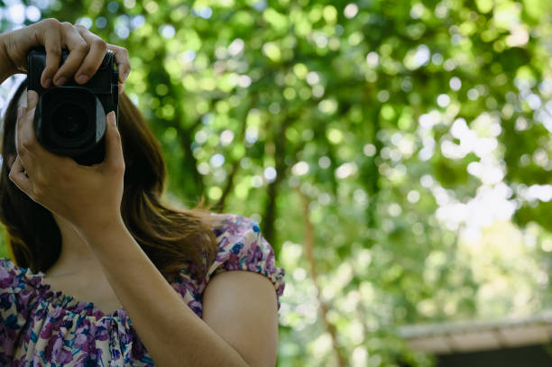 istock Young woman using camera with beautiful bokeh , learning , travel and recreation concept 1356788016