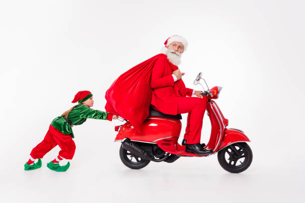 Photo of team people old man ride scooter hold sack kid push wear santa elf costume isolated grey color background Photo of team people old man ride scooter hold sack kid push wear santa elf costume isolated grey color background. elf sitting stock pictures, royalty-free photos & images