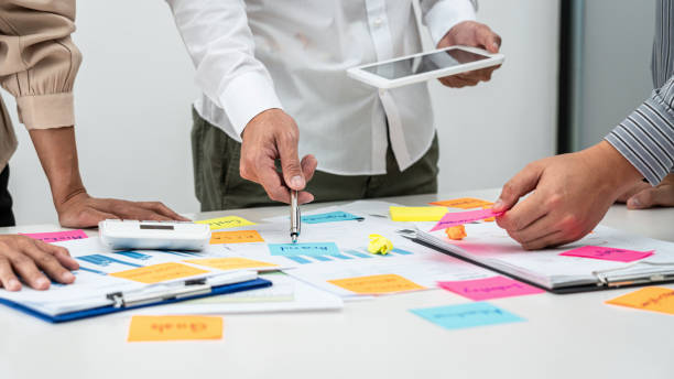 istock Business people team, businessman holding tablet to looking for checking data and pointing post it notes 1356788251