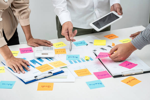 istock Business people team, businessman holding tablet to looking for checking data and pointing post it notes 1356788290